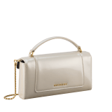 Serpenti Forever phone case in white agate varnished calf leather with black nappa leather lining. Captivating snakehead magnetic closure in gold-plated brass embellished with white agate enamel and gold-plated brass scales, and black onyx eyes. 295159 image 2