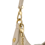 Serpenti Ellipse small crossbody bag in Urban grain and smooth ivory opal calf leather with flamingo quartz pink grosgrain lining. Captivating snakehead closure in gold-plated brass embellished with black onyx scales and red enamel eyes. 1204-UCLa image 5