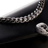 Serpenti Forever Maxi Chain small crossbody bag in black palmellato leather with black nappa leather lining. Captivating snakehead closure in palladium-plated brass embellished with black onyx scales and red enamel eyes. MCN-PL-B image 4