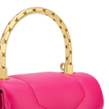 Serpenti Reverse micro top handle bag in truly tourmaline fuchsia Metropolitan calf leather with royal ruby red nappa leather lining. Captivating snakehead magnetic closure in gold-plated brass embellished with red enamel eyes. SRV-NANOREVERSE-MCL image 6