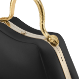 Serpentine small top handle bag in black smooth calf leather with emerald green nappa leather lining. Captivating snake body-shaped top handle in gold-plated brass embellished with engraved scales and red enamel eyes, press button closure and light gold-plated brass hardware. SRN-1268a image 5