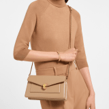 Serpenti Forever small crossbody bag in Travertine calf leather with Travertine nappa leather lining. Captivating snakehead magnetic closure in gold-plated brass embellished with beige noisette enamel and gold-plated brass scales, and black onyx eyes. 295079 image 1