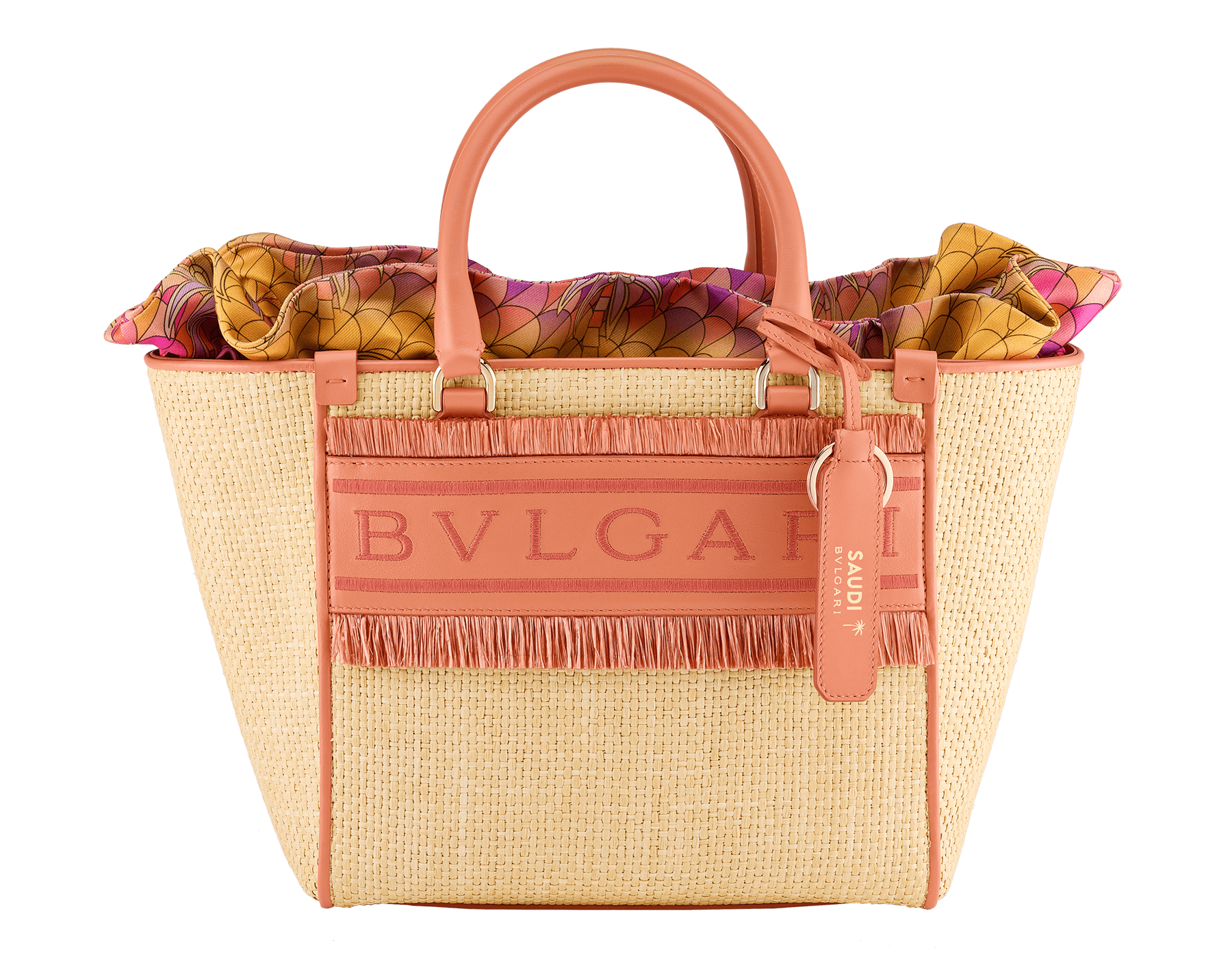Bulgari Logo medium tote bag in beige raffia with coral carnelian orange calf leather details and customisable tag with hot stamped "Saudi" inscription on one side, coral carnelian orange raffia fringes and beetroot spinel fuchsia nappa leather lining. Iconic Bulgari logo stitched motif, detachable satin satchel with multicoloured print outside and beetroot spinel fuchsia inside, and drawstring closure with captivating snakeheads in light gold-plated brass. Special Resort Edition exclusive to Saudi Arabia. 292510 image 1