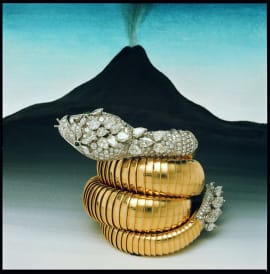Serpenti Heritage secret yellow gold watch with diamonds on head and tail, volcano in the back.