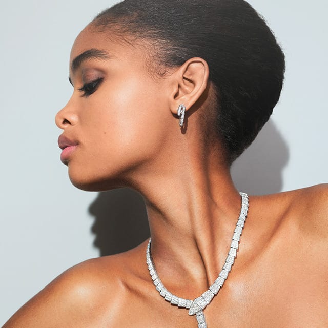 Blesnya wearing Serpenti earrings in white gold with diamonds.