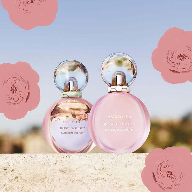 Rose Goldea Blossom Delight Eau de Parfum and Eau Toilette, Roman sky backdrop.