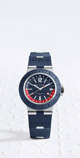 Bvlgari Aluminium GMT watch with blue rubber bezel, strap and dial and model wearing the watch, sky backdrop.