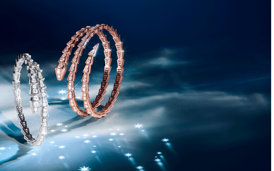 Creative picture representing Serpenti bracelets in rose and white gold white diamonds.