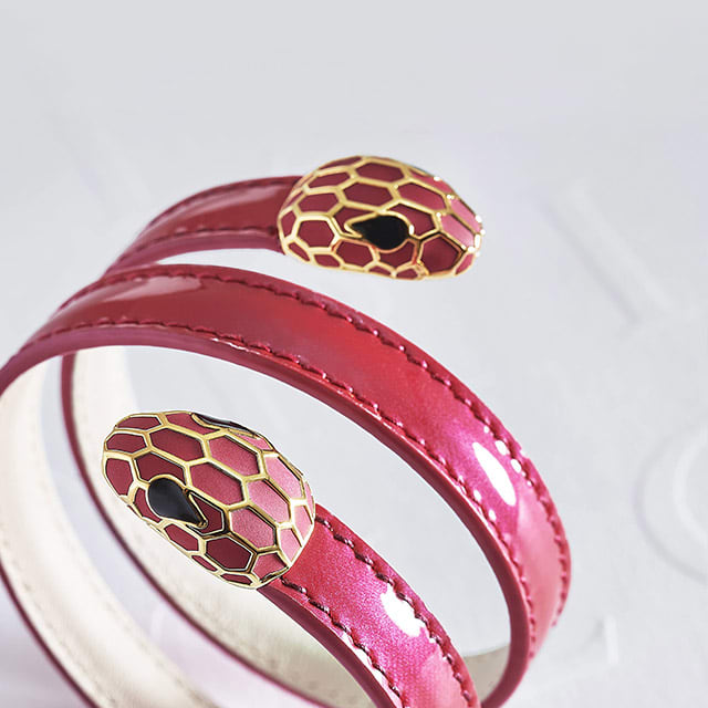 Serpenti Forever multi-coiled rigid Cleopatra bracelet in Amaranth Garnet red calf leather with a varnished and pearled effect. Gold-plated brass snakehead décor enameled in full matte Amaranth Garnet red, finished with eyes in black enamel.