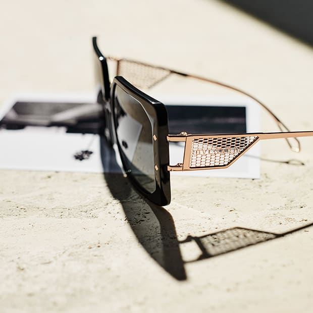 Serpenti Vipermesh black acetate sunglasses with metallic microscale mesh on the temples, side view.