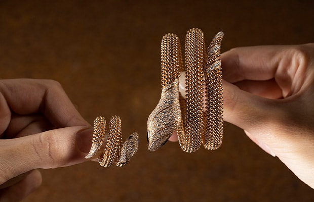 Different steps in the making of Serpenti Viper rose and white gold bracelets with diamonds.