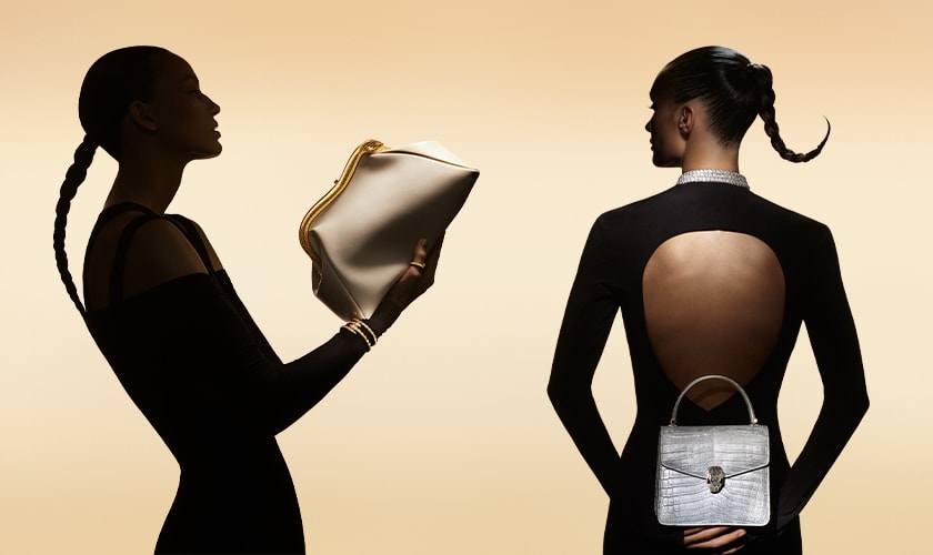 Models, one from the back and one from the side, holding a Serpenti Forever bag and a Serpentine pouch.
