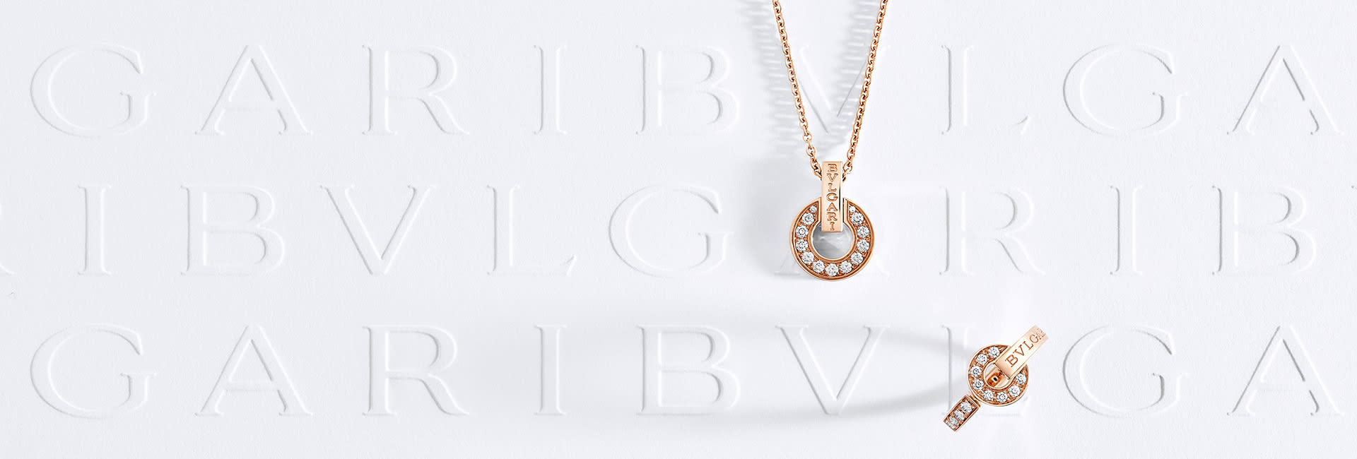 A Divas' Dream rose gold necklace with diamonds and malachite, and a BVLGARI BVLGARI openwork necklace in rose gold with pavé diamonds.