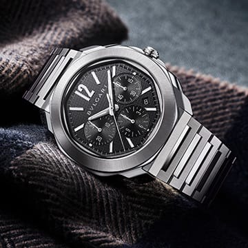 Octo Roma Chronograph watch in stainless steel with black dial, creative shot.