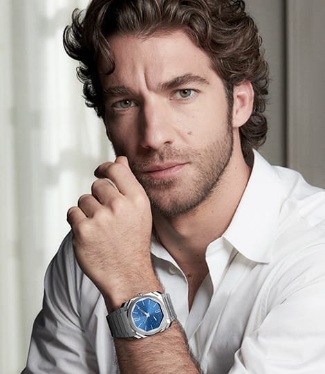 Lorenzo Viotti wearing the Octo Finissimo Automatic steel watch with blue dial and same watch on white backdrop.