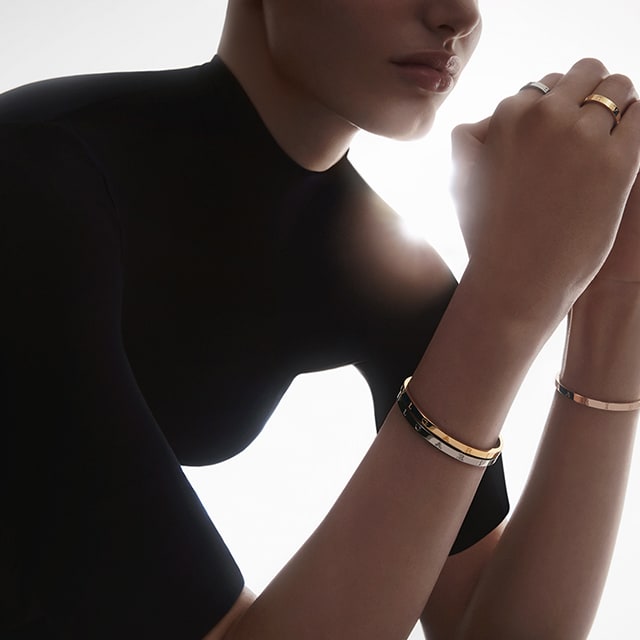 Model wearing Bulgari Bulgari rings and bracelets.