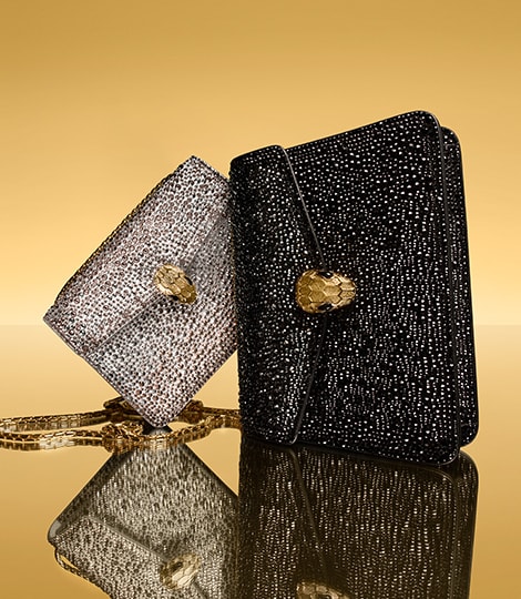 Serpenti Forever small and large bags in gold dégradé and black suede with crystal dust, yellow backdrop.