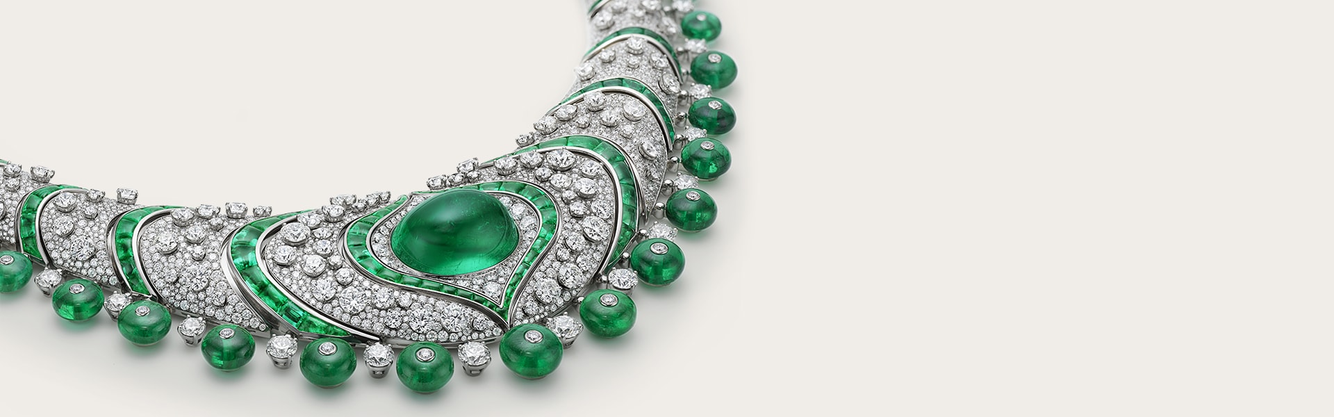 Emerald Lotus High Jewelry platinum necklace with emeralds and diamonds, close-up.