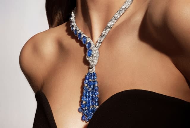 Model wearing the Mediterranean Sapphire Mediterranea High Jewelry white gold necklace with sapphires and diamonds, close-up.