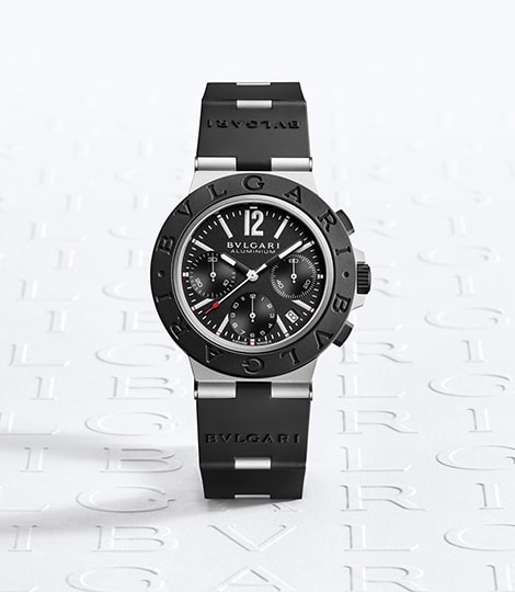 Bulgari Aluminium watch with chronograph, aluminum case, black rubber bracelet, logo backdrop.