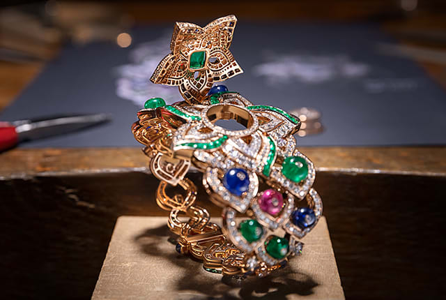 The making of the Oriental Buds High Jewelry secret watch with emeralds and diamonds. Pair with the Oriental Buds necklace.