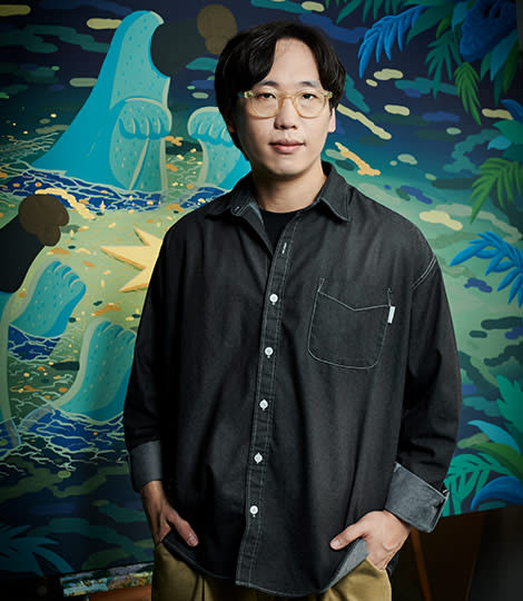 Contemporary artist Sunwoo Kim, who collaborated on the Serpenti in Art project, in front of his painting.
