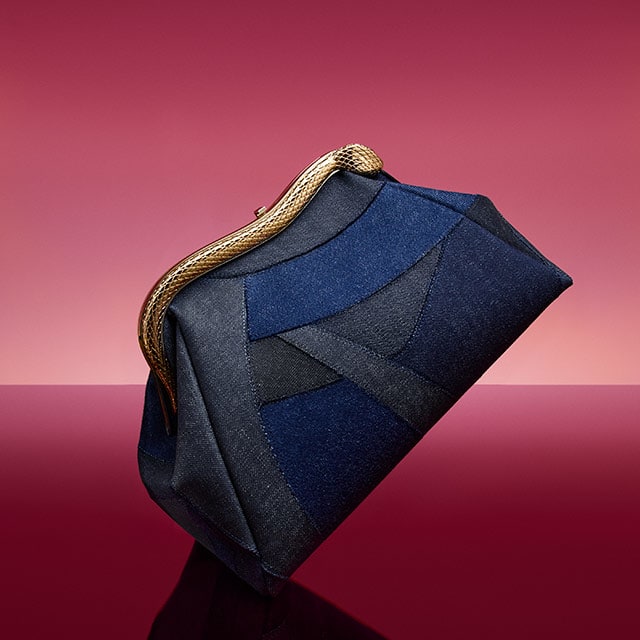 Serpentine medium pouch in blue Patch Denim with emerald green nappa leather lining.
