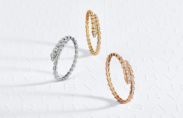 Serpenti Viper bracelets in rose, yellow and white gold with diamonds, white Bulgari logo backdrop.