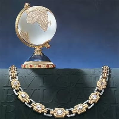 Bulgari vintage advertising campaign withgold and diamond necklace, precious globus and Bulgari infinitum logo.