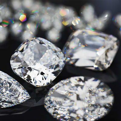 Close up of Bulgari diamonds in multiple shapes, sizes and cuts on black background.