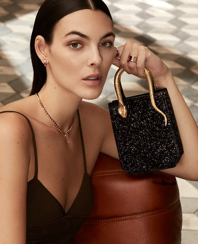 Vittoria Ceretti holding a black Serpentine Tote Crystal Sparkle bag with snake handle, Roman interior.
