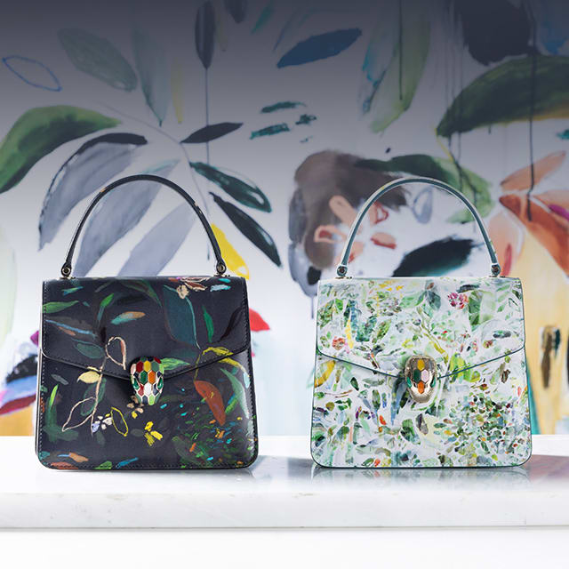Serpenti Forever top handle bags in white and black calf leather with leaves motif, designed by artist Sophie Kitching.
