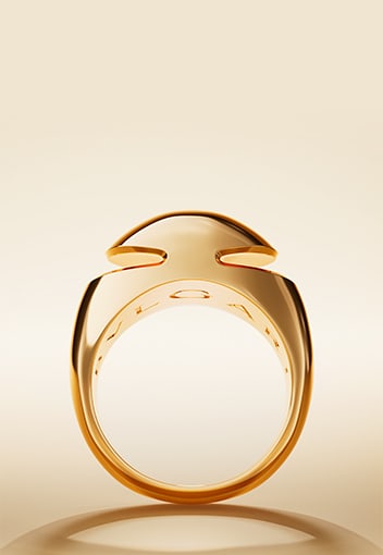 Bulgari Cabochon 18 kt yellow gold ring with Bulgari logo engraving inside, neutral backdrop.