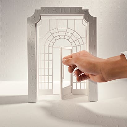Hand opening the model of the Bulgari door to represent Bulgari's book an appointment service.