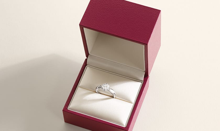 Bulgari Torcello engagement ring in platinum with brilliant-cut diamond inside an open red box.