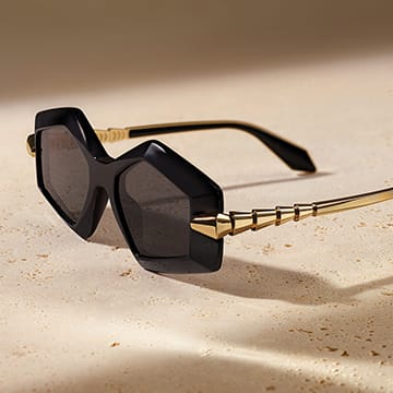 Serpenti Viper sunglasses with a geometric black acetate frame and gold-finished scale-motif temples.