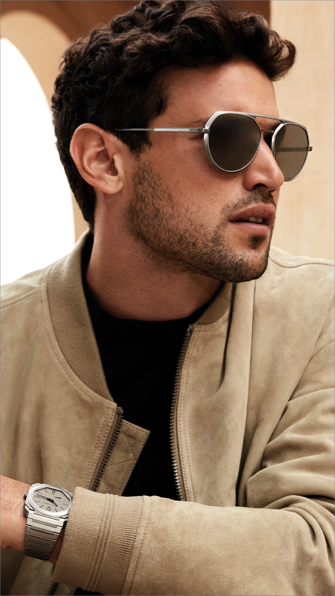 Man wearing Octo Finissimo aviator double-bridge sunglasses in titanium, Roman backdrop.