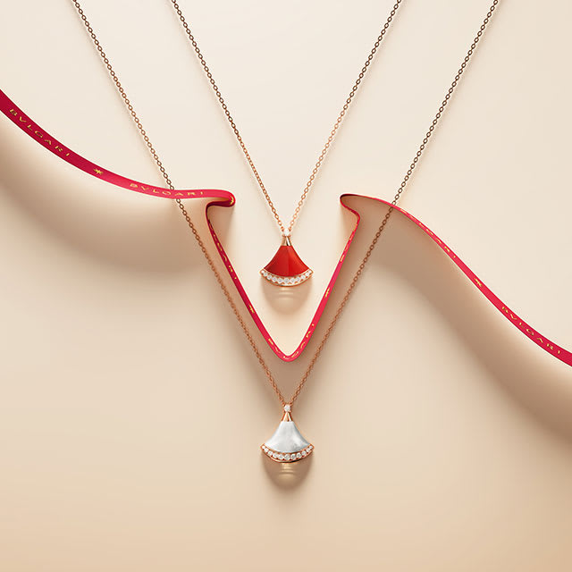 Divas' Dream necklaces, intertwined with a red ribbon.