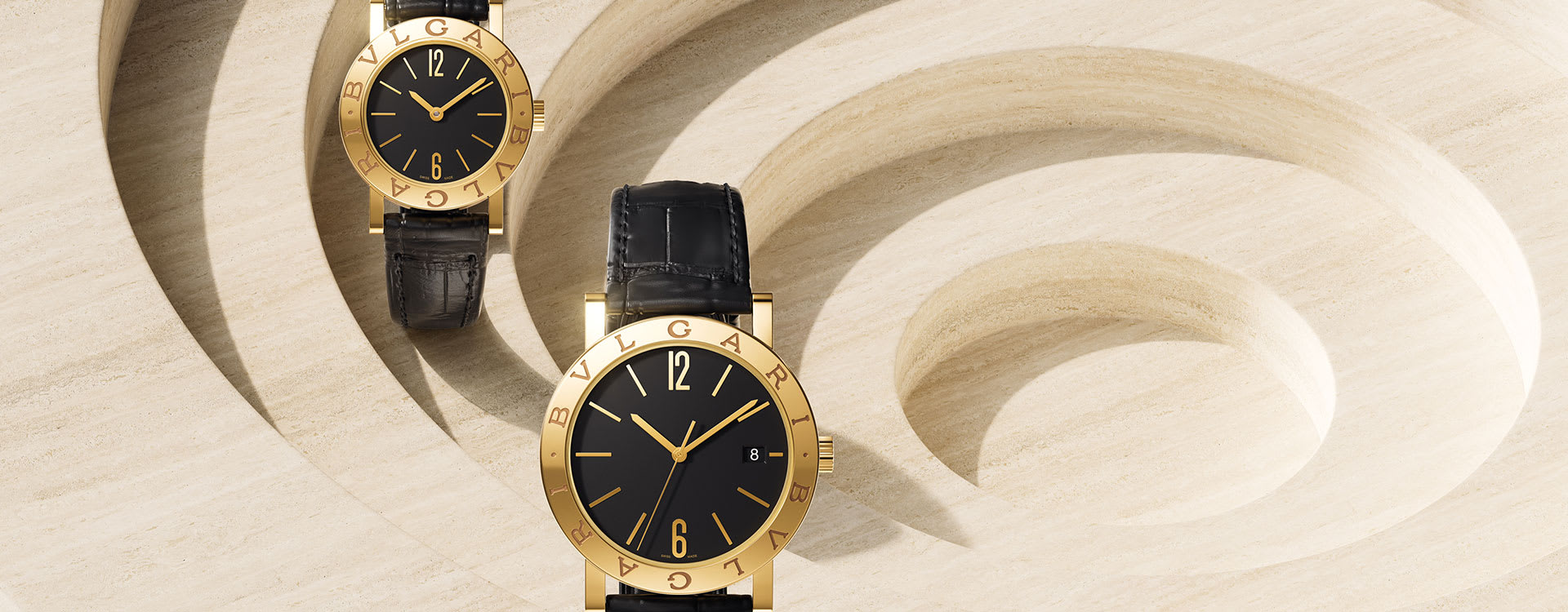Bvlgari Bvlgari watches with yellow gold case in two different sizes, black dial and alligator strap.