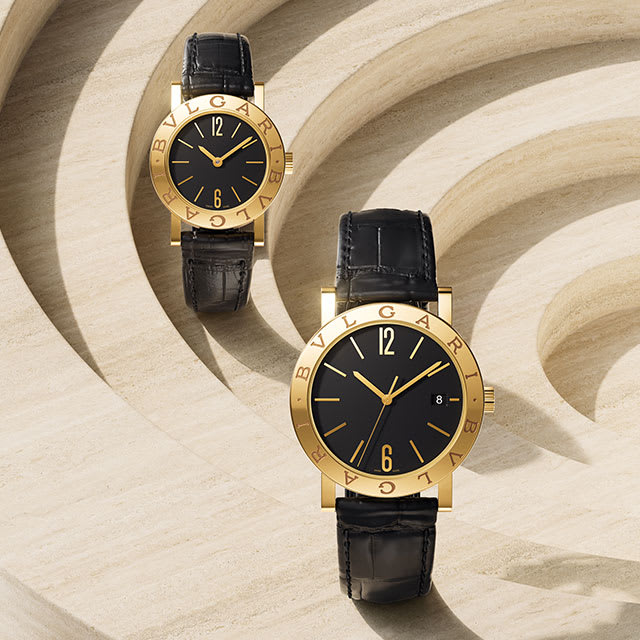 Bvlgari Bvlgari watches with yellow gold case in two different sizes, black dial and alligator strap.