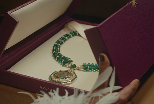 Box containing the High Jewellery necklace with emerald beads and an ancient coin featuring Augustus.