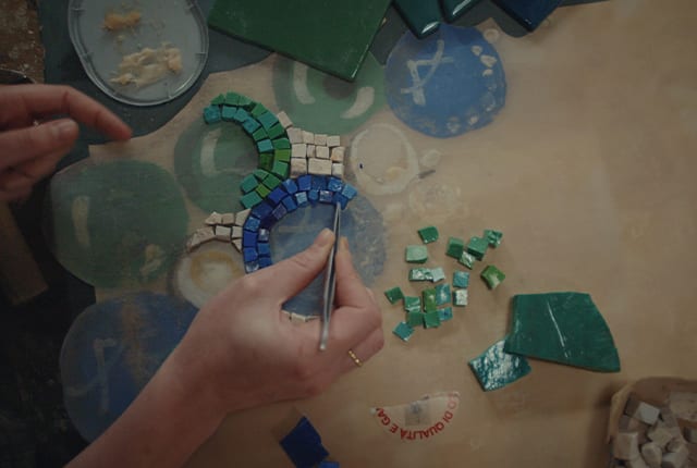 Craftsman assembling a mosaic by hand in the interiors of the Bulgari Hotel Roma.