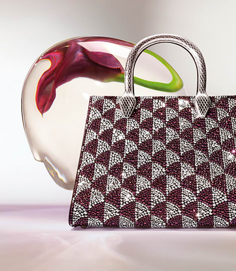 Serpenti Sugarloaf black calf leather bag with top handle, Calla Matelassé motif and snakehead closure.
