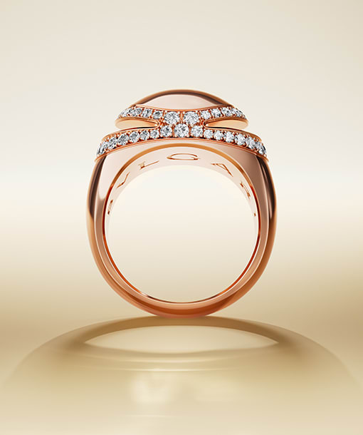 Bulgari Cabochon 18 kt yellow gold ring with Bulgari logo engraving inside, neutral backdrop.