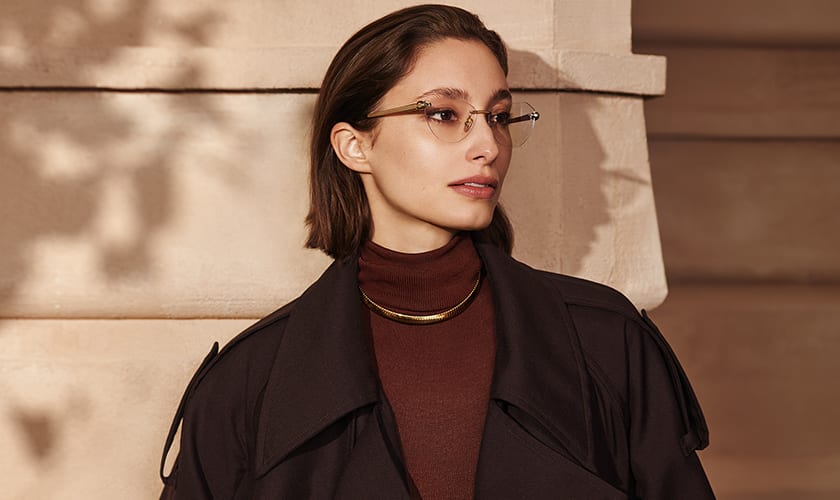 Model wearing Serpenti Forever rimless cat eye frames and a Bvlgari Tubogas gold necklace.