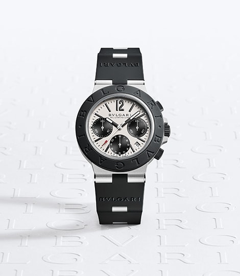Bvlgari Aluminium GMT watch in aluminium and black rubber, departure board in the background.