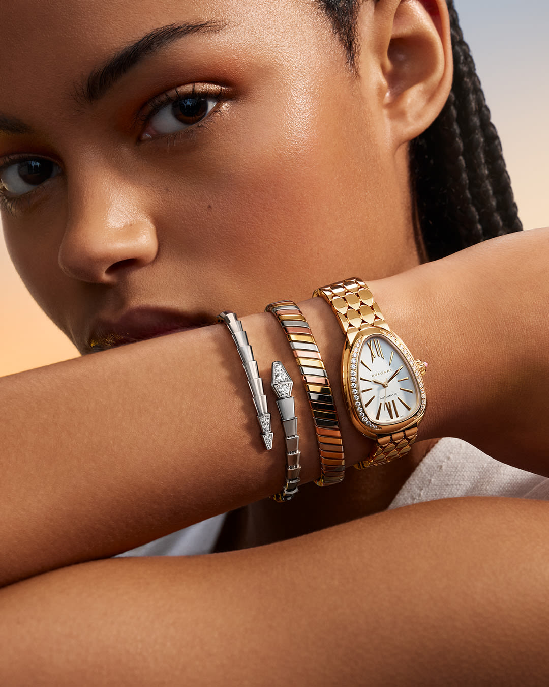 Model wearing Bvlgari Tubogas bracelet and Serpenti bracelet and watch.