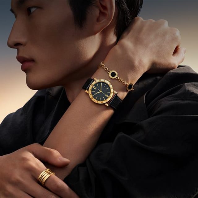 Model wearing Bvlgari Bvlgari watch and Bzero1 ring.