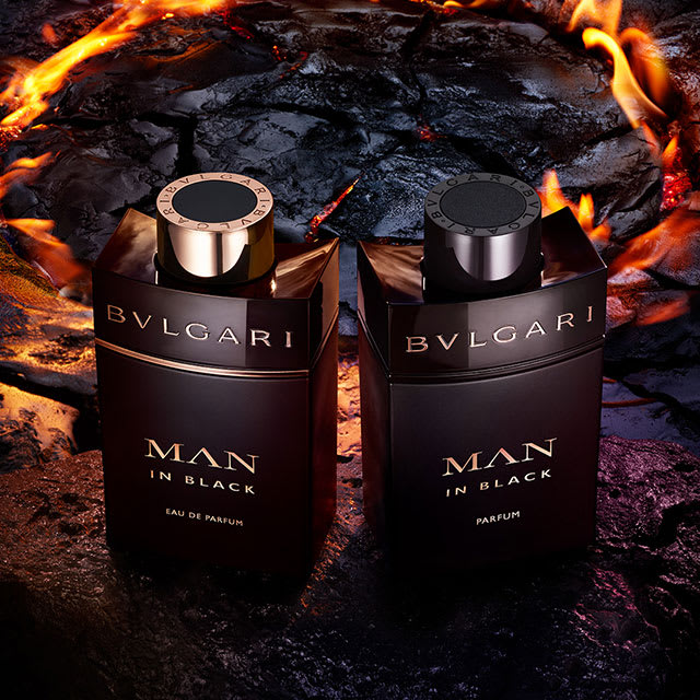 Bvlgari Man in Black Eau de Parfum black bottle placed on a rock, purple sky in the back, close-up.