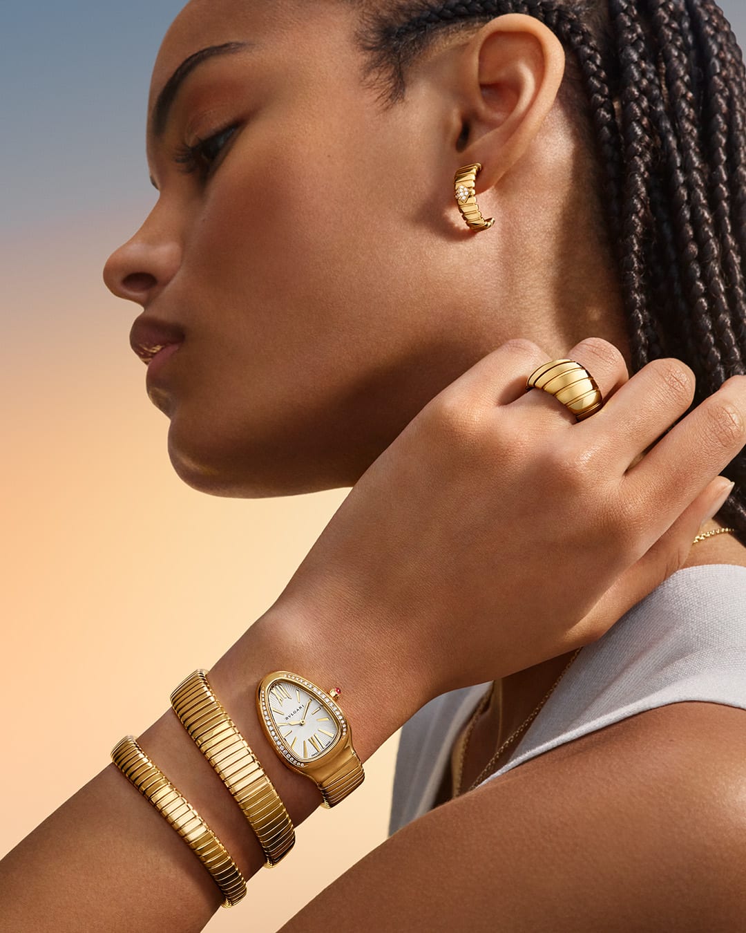 Model waring Bvlgari Tubogas jewellery and Serpenti watch.